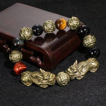 Pi Yao Wealth Bracelet made of black obsidian, featuring the Om Mani Padme Hum mantra for protection and abundance.