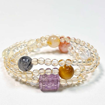 Protective choker necklace combining the energies of Yellow Aura Quartz, Black Rutilated Quartz, and Tiger's Eye for abundance.