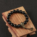 Om Mani Padme Hum Mala Bracelet made of antique brass beads and black obsidian.