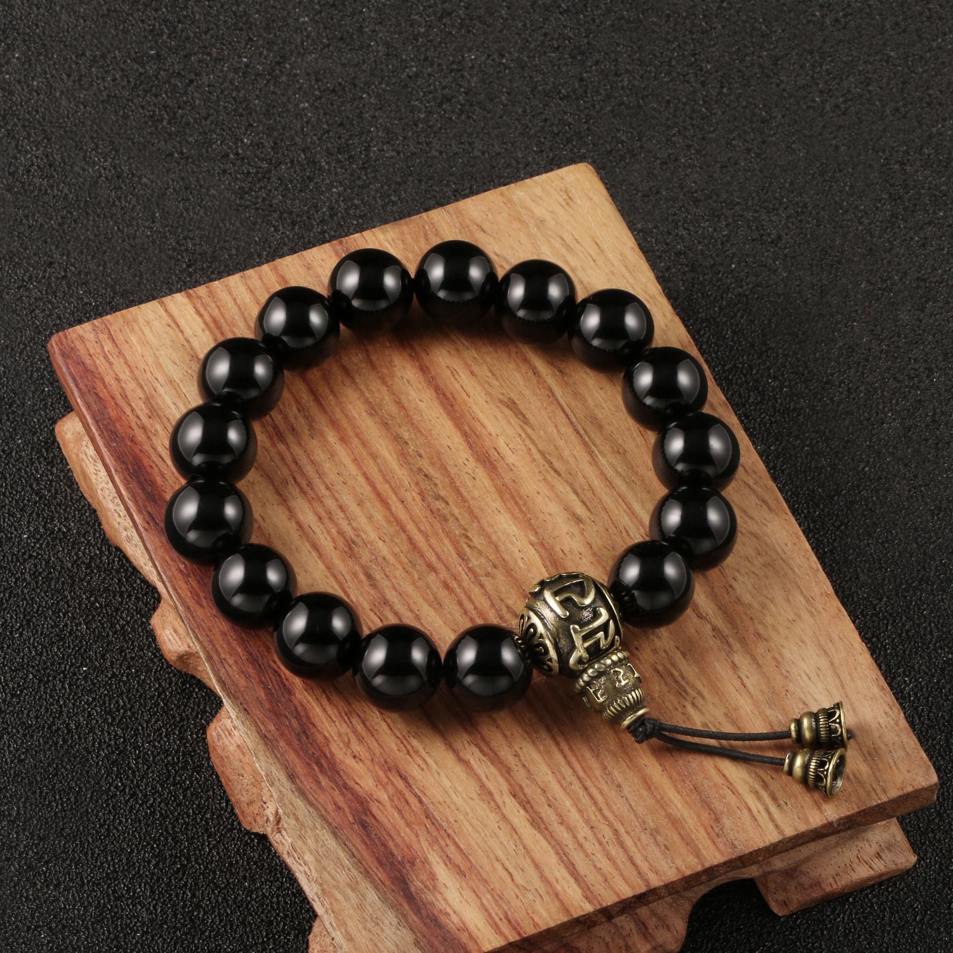 Om Mani Padme Hum Mala Bracelet made of antique brass beads and black obsidian.