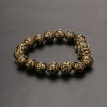 Brass mala bracelet for men featuring a Pi Yao charm for wealth and mantra beads for protection.