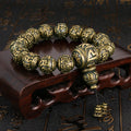 Mala bracelet for meditation and protection, featuring black obsidian and antique brass with the sacred mantra.