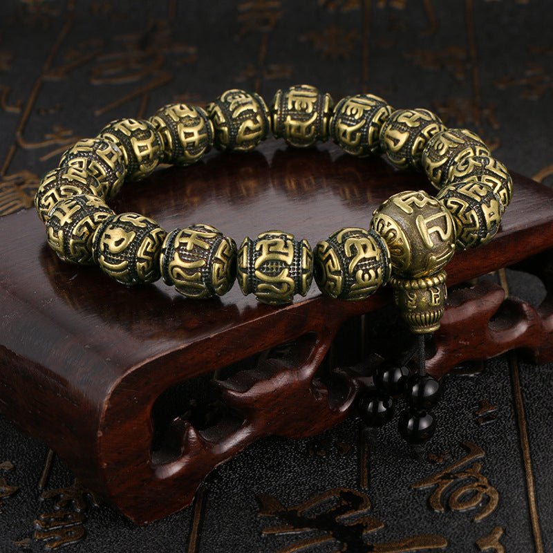 Close-up of the individual antique brass and black obsidian beads on the Om Mani Padme Hum bracelet.