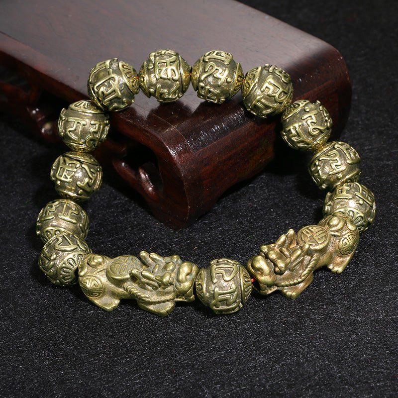 Black Obsidian Pi Yao bracelet for spiritual protection and attracting financial abundance, engraved with Om Mani Padme Hum.