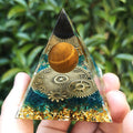 Glass crystal pyramid with clock motif for decorative focus and energy cleansing.