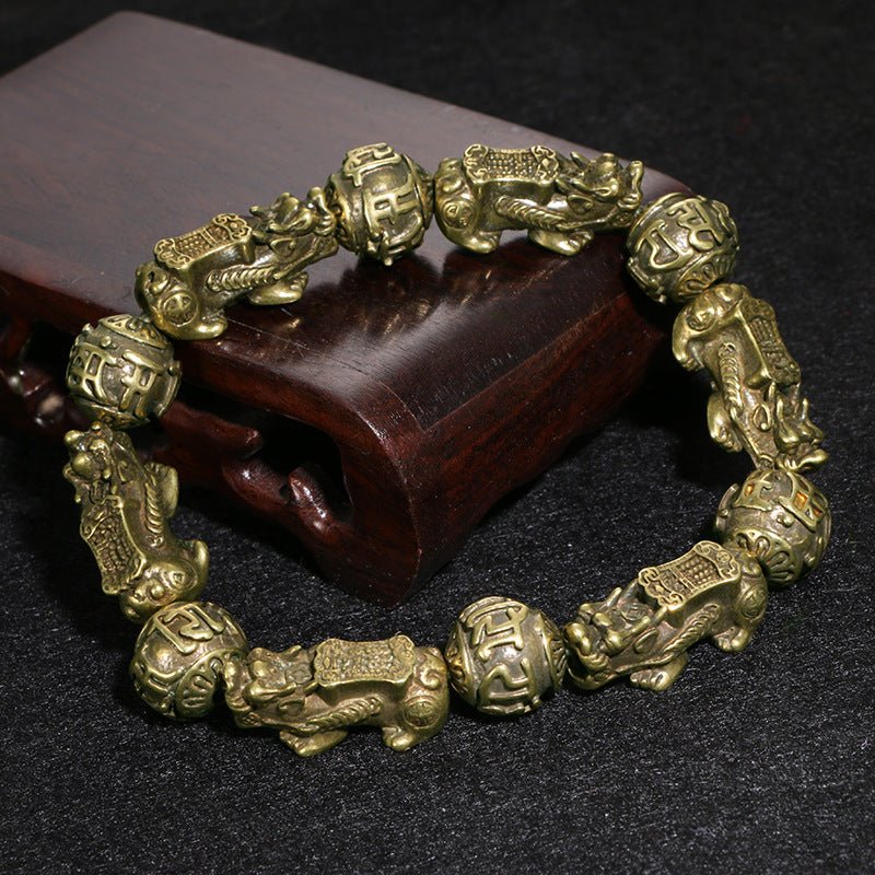 Sacred Om Mani Padme Hum and Pi Yao charm combined on a powerful black obsidian mala bracelet.