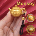 Personalized Monkey Zodiac keychain with spinning teapot, a clever and playful charm for wit, joy, and clever problem-solving.