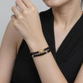Woman wearing the gray moonstone and black onyx double wrap bracelet on her wrist.