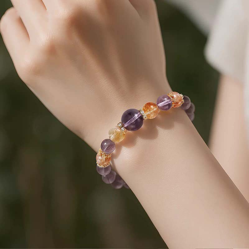 Amethyst and Citrine stacking bracelet worn on wrist, a natural crystal point accessory for wealth and intuition.