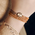 Woman wearing the olive seed bracelet on her wrist