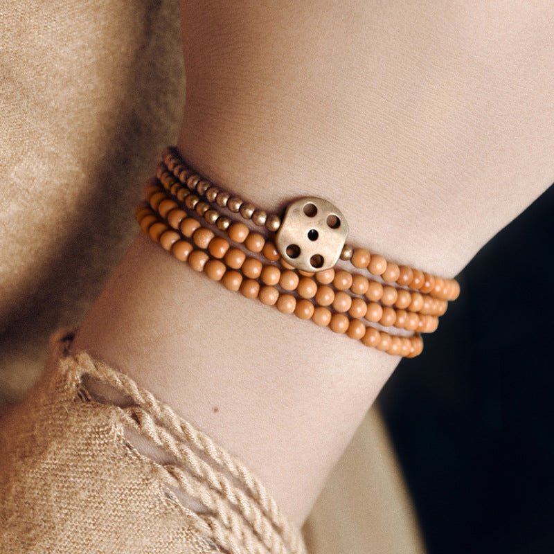 Woman wearing the olive seed bracelet on her wrist