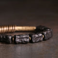 Unisex bracelet made of dark ebony wood beads and brass