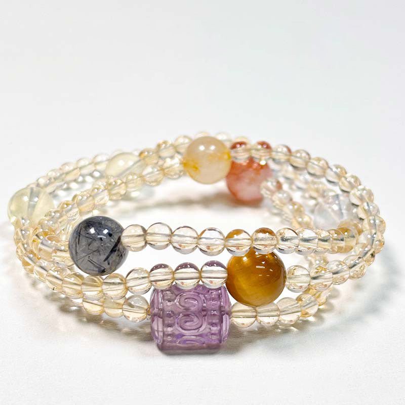 Protective choker necklace combining the energies of Yellow Aura Quartz, Black Rutilated Quartz, and Tiger's Eye for abundance.