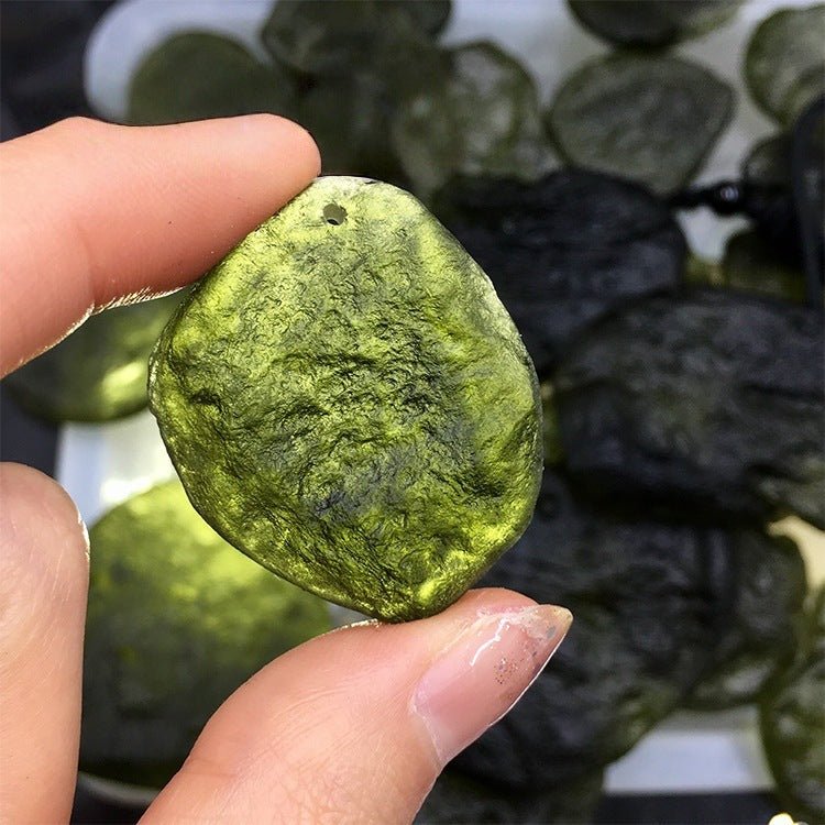 Powerful energy transformation tool: a raw Moldavite pendant from the Czech Republic on a sleek necklace for spiritual growth.