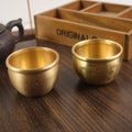 An elegant brass Feng Shui jar for wealth, doubling as a meaningful decor piece to enhance the energy of any space.