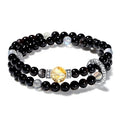 A stone jewelry combination of intuitive gray moonstone and grounding black onyx in a double wrap style.