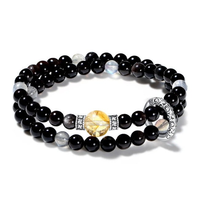A stone jewelry combination of intuitive gray moonstone and grounding black onyx in a double wrap style.