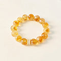 Yellow Aura Quartz Wealth Bracelet featuring a Citrine Tower bead for attracting success and abundance.
