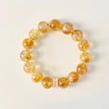 Wealth bracelet combining the energies of Yellow Aura Quartz rounds and a focal Citrine tower point for abundance.