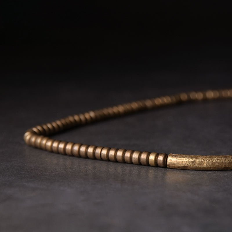 Brass mala beads and charm on the protection bracelet