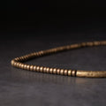 Brass mala beads and charm on the protection bracelet