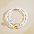Polished metallic stone bead representing the Metal element on the Five Elements balancing bracelet.