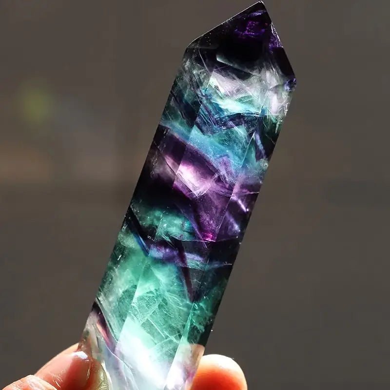 Natural Rainbow Fluorite Point, a single terminated generator crystal for energy healing and chakra balancing.