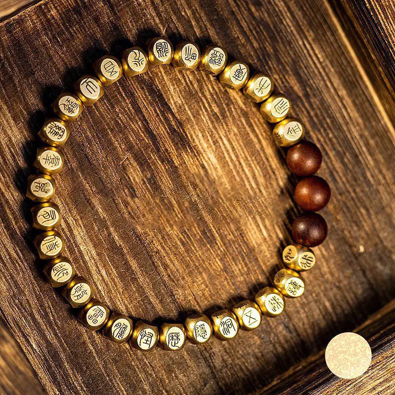 Taoist Golden Light Mantra protection bracelet with an engraved copper talisman for positive energy.