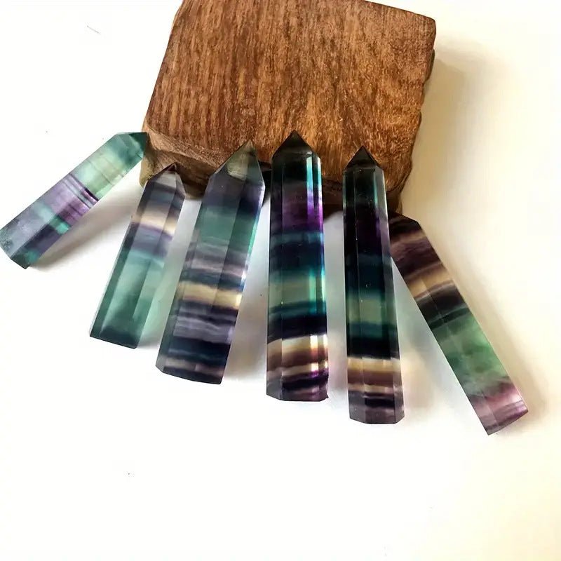 Stunning natural rainbow fluorite point with bands of purple, blue, and green for balancing the crown, throat, and heart chakras.