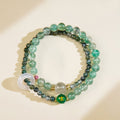 Green aventurine or moss agate bead symbolizing the Wood element for growth and vitality.
