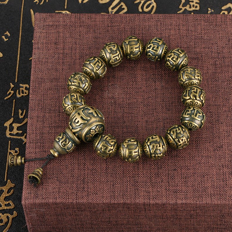 Single strand Om Mani Padme Hum bracelet with antique brass and black obsidian beads.