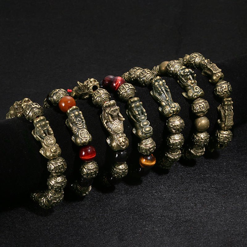 Detailed craftsmanship of the black obsidian Pi Yao bracelet, showing the engraved mantra and mystic knot.