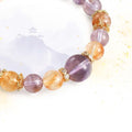Close-up detail of the natural, unpolished Amethyst and Citrine points on the energy bracelet.