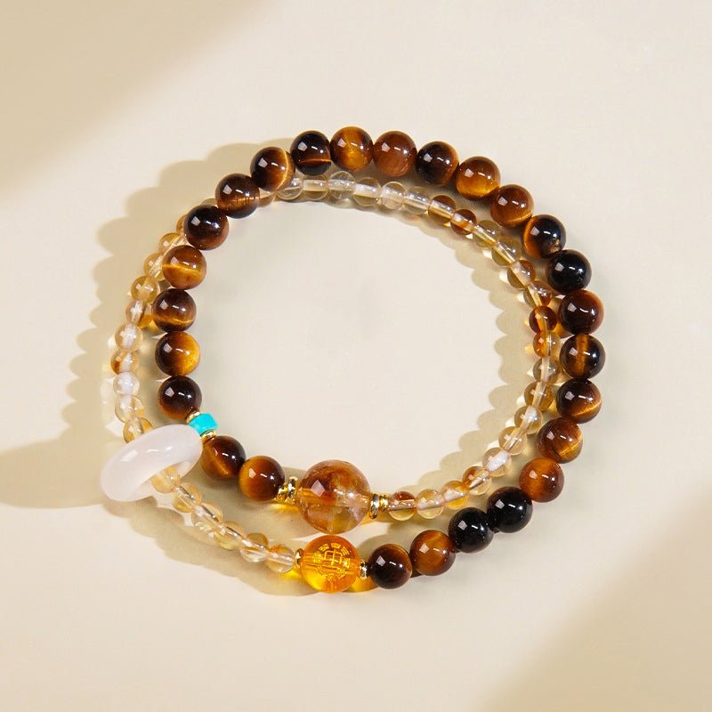 Brown tiger's eye or yellow jasper bead grounding the Earth element for stability.