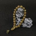 Close-up of the sacred Sanskrit mantra engraved on the antique brass Amitabha Buddha bracelet.