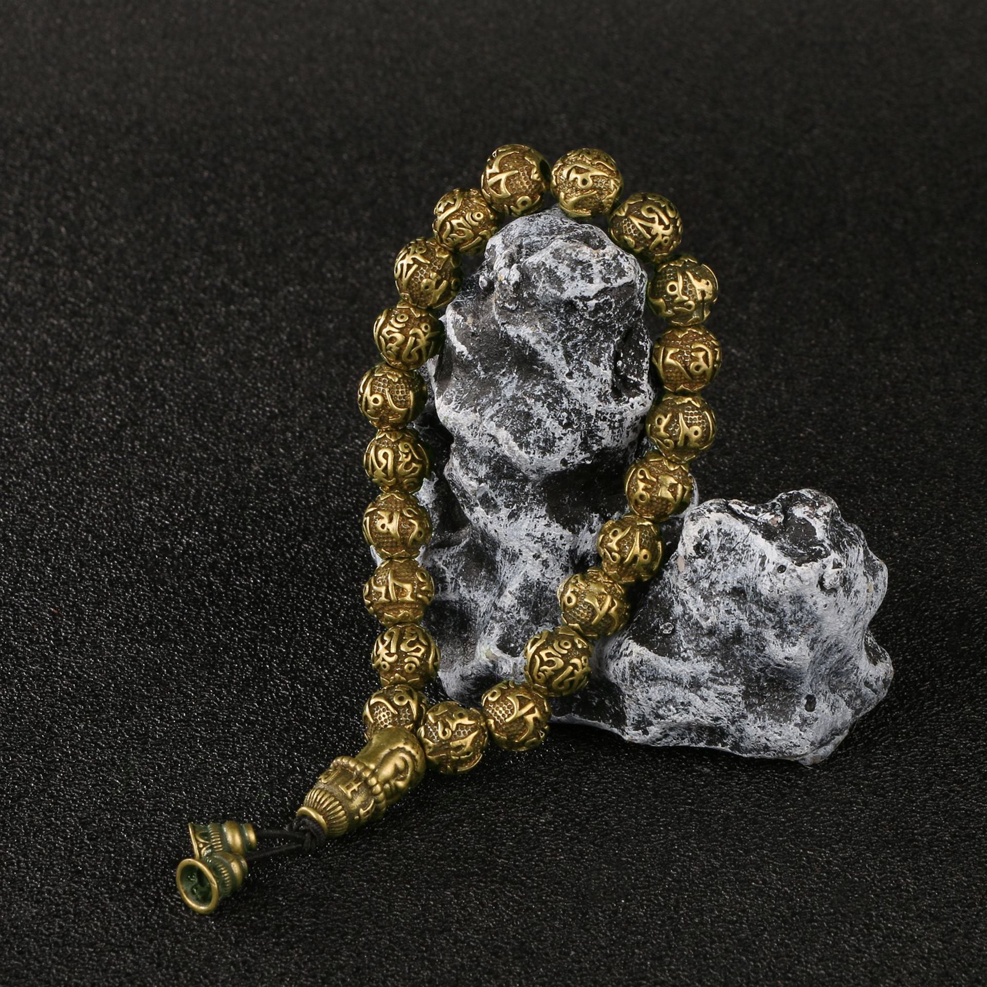 Close-up of the sacred Sanskrit mantra engraved on the antique brass Amitabha Buddha bracelet.