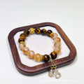 Close-up detail of the double wrap design, showing the polished Tiger's Eye and Citrine beads.