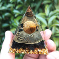 Tiger's eye pyramid with clock design for focus, time management, and grounding.
