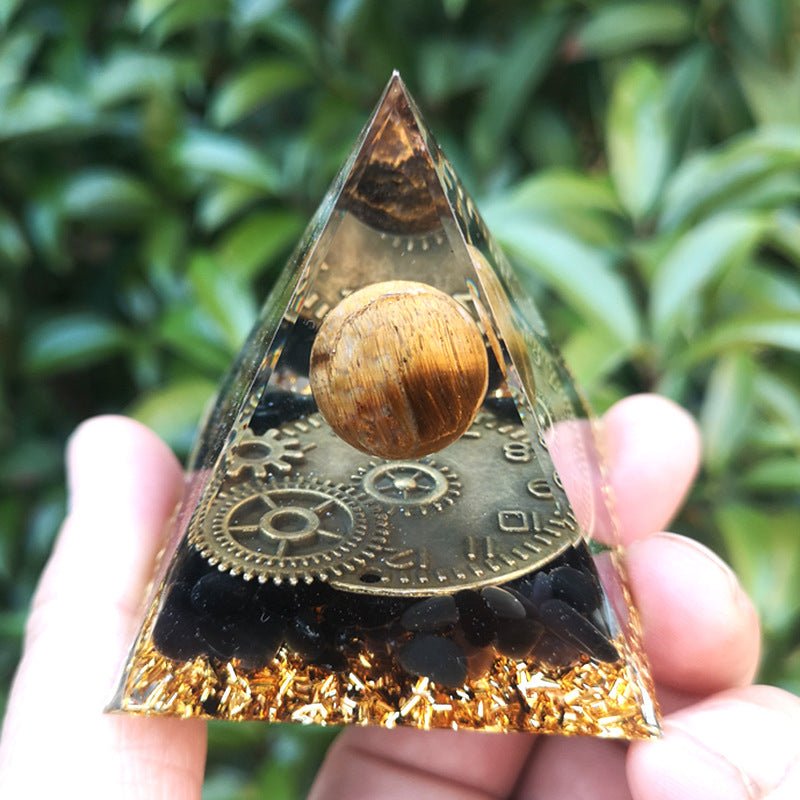 Tiger's eye pyramid with clock design for focus, time management, and grounding.