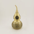 Close-up detail of the Cai (财) character for wealth and abundance, engraved on the large brass Feng Shui gourd.