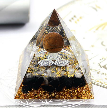 Tiger's eye pyramid with triple spiral for vitality, protection, and energy movement.