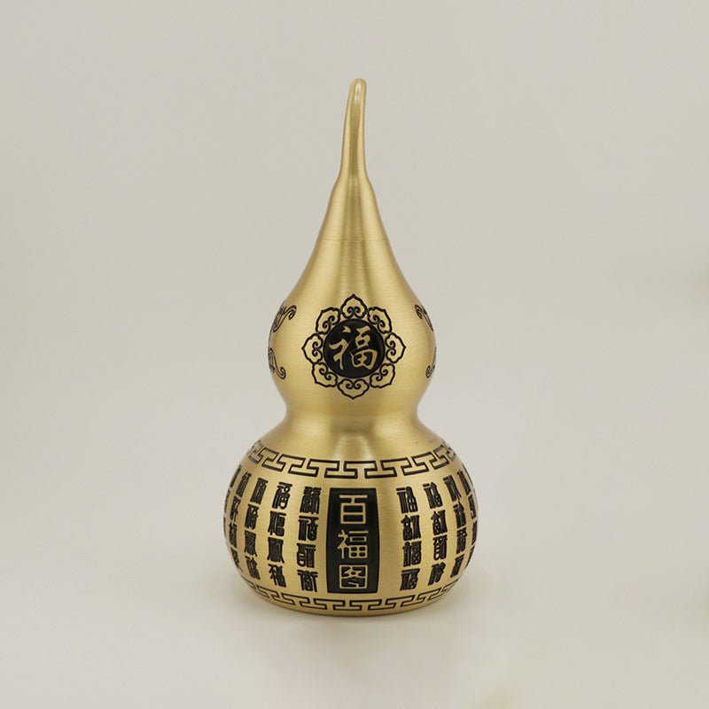 Close-up of the Chinese character Fu (福) for blessings and happiness, engraved on the large brass Feng Shui gourd.