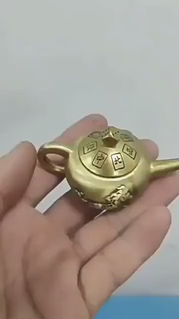 Brass Spinning Teapot fidget toy, an "Instant Win" Mahjong-themed good luck charm for gamers.